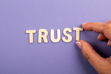 TRUST. Letters with text on a purple background