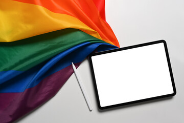 Mock up digital tablet with LGBT rainbow flag on white background.