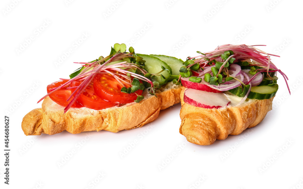 Tasty croissants with vegetables and micro green on white background
