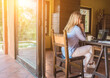 © Andrii IURLOV - Woman talking on video call with Family, using smartphone and drinking tea. Online chat. Spend free time on terrace. Staying connected, Social distancing, internet, chatting.