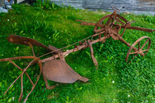 Old Rusty Plow Lying On The Grass