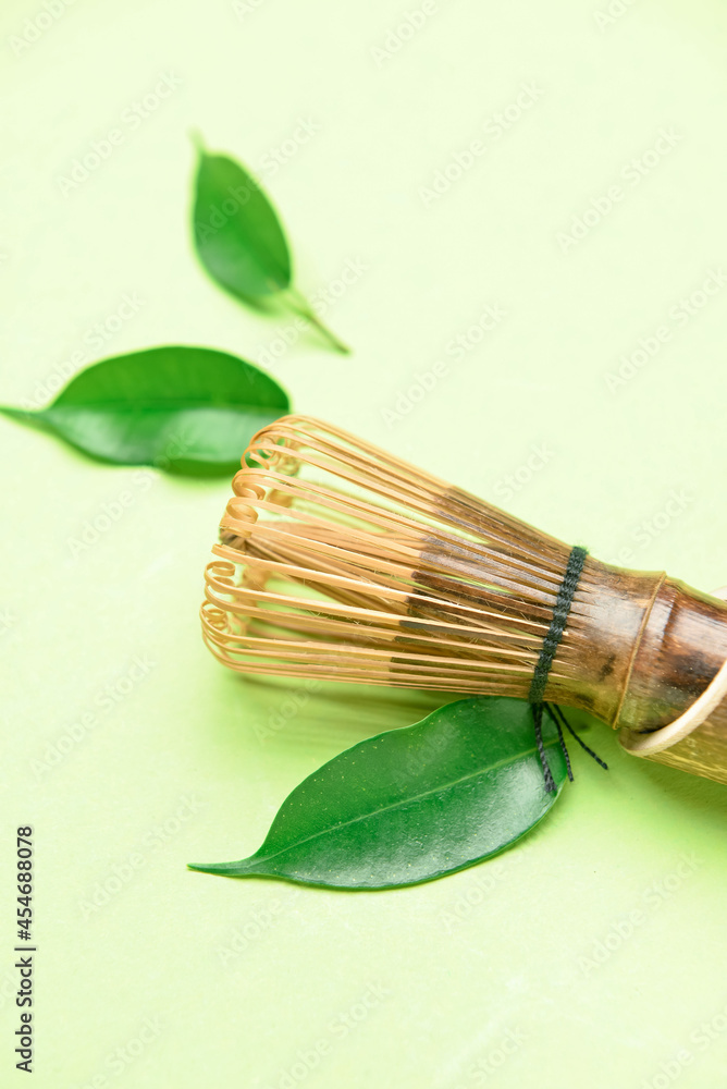 Bamboo chasen and green leaves on color background, closeup