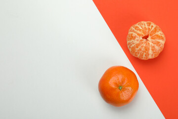 Tasty fresh mandarins on two tone background