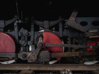 Poster - Closeup shot of red train wheels in a railway station