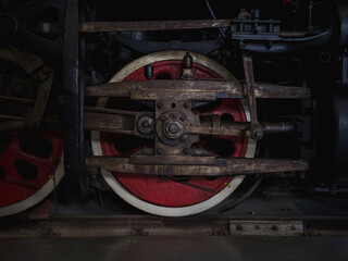 Poster - Closeup shot of red train wheels in a railway station