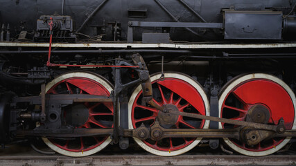 Poster - Closeup shot of red train wheels in a railway station