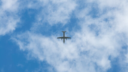 Wall Mural - Commercial passenger aircraft across flying over head. Plane fly in day