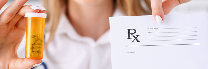 Wall Mural - Female doctor hands hold prescription