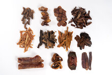 Various Dehydrated Beef And Chicken Products For Dogs (trachea, Noses, Ears, Necks, Cut Lungs, Udder, Liver, Heart, Stomach, Testes And Penis). Homemade Pet Treats. White Background, Copy Space.