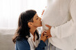 © (JLco) Julia Amaral - Caring young woman kissing her wife's belly bump