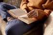canvas print picture - people, season and leisure concept - close up of woman in warm sweater reading book at home