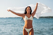 © Syda Productions - people, summer and swimwear concept - happy smiling young woman in bikini swimsuit with cover-up on beach
