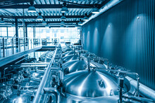 Private Microbrewery. Modern Beer Plant With Brewering Kettles, Tubes And Tanks Made Of Stainless Steel