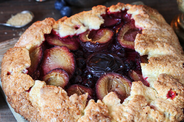 Canvas Print - Traditional round plum pie on the table.