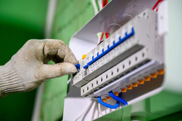 Close-up of the control panel circuit breaker. An electrician tests old wiring and the installation of switches and electrical systems in homes and buildings.