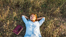 High Angle View Of Woman Lying On Grass