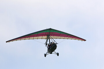 Poster - Ultralight airplane flying in a blue sky