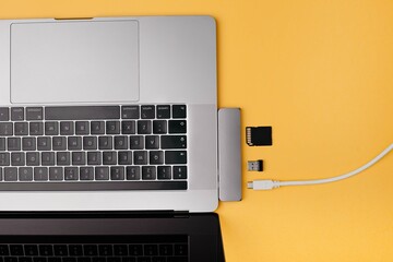 Wall Mural - Close-up photo of type-c hub with cables and card connected with laptop