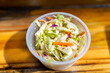 Closeup of shredded cabbage New England cole slaw coleslaw fresh salad with DJ's clam shack with mayonnaise serving in small plastic cup container in Key West, Florida fast food cafe restaurant