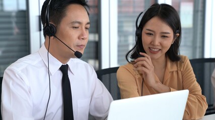 Business people wearing headset working actively in office . Call center, telemarketing, customer support agent provide service on telephone video conference call.