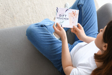 Poster - Young woman with gift voucher for massage at home