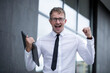 © Erika - Happy winner. Man business. Male. Photo. Background. Office. Boss. Working. Life.