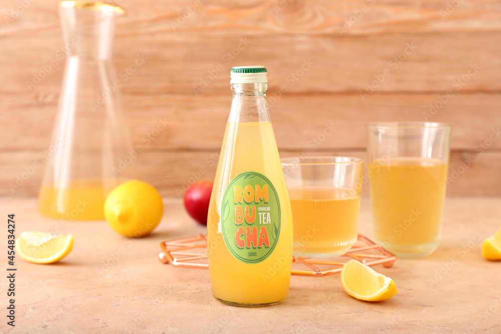 Bottle of tasty kombucha tea on table