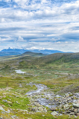 Sticker - Mountain creek with a view of the rolling mountainous landscape