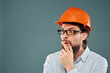 © SHOTPRIME STUDIO - surprised man orange helmet on the head success isolated background