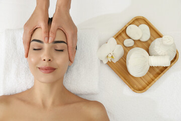 Wall Mural - Young woman receiving facial massage in spa salon, top view