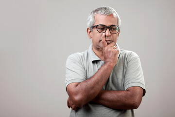 Wall Mural - Mature man of Indian ethnicity with a thoughtful expression