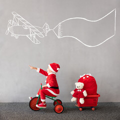 Canvas Print - Happy child riding bike. Christmas holiday concept