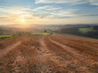 © Lukasz - Rural landscape in the German city of Velbert at sunrise in the Bergisches land region. Mown field in the foreground and green woods in the background.