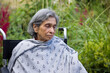 © Paul Maguire - Old Indian woman in a wheelchair, looking sad. UK