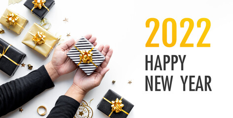 Wall Mural - 2022 happy new year celebration concepts with gift box and ornament in golden color on dark backgrou