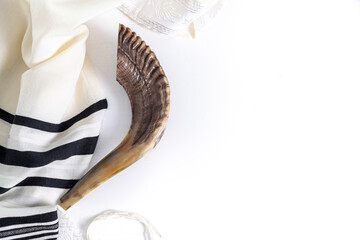 Shofar (horn) and tallit on a white background. Traditional symbol of the Jewish holiday. Top view