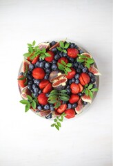 Wall Mural - Holiday cake with cream and fruits on white background