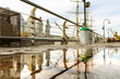 © HC FOTOSTUDIO - Reflections of buildings and other objects in the water surface of the street after a rain.