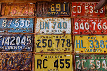 Vintage License Plates Affixed To A Garage Wall