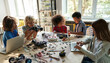 © insta_photos - Diverse school children students group building robotic cars using computers. Happy multicultural kids learning programming robot vehicles sitting at table at STEM education coding engineering class.