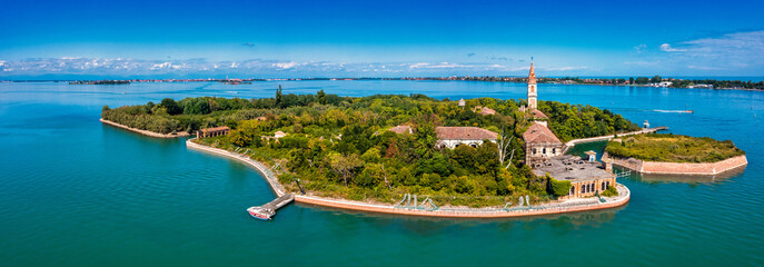 Aerial view of the plagued ghost island of Poveglia in the Venetian lagoon, opposite Malamocco along the Canal Orfano near Venice, Italy.