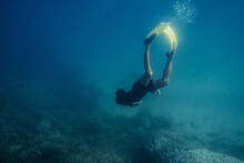 Underwater View Of Man Diving In A Blue Ocean.Copy Space