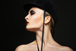 Fashion horsewoman wearing black hat