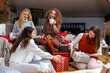 © ako-photography - young girls having fun wrapping gifts at home, great teamwork of friends packing presents for christmas
