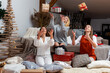 © ako-photography - young girls having fun wrapping gifts at home, great teamwork of friends packing presents for christmas