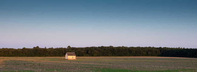 Poster - old shed in empty cornfield at sunset in Parc naturel régional Loire-Anjou-Touraine