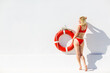 © Angelov - sexy young woman with Lifebuoy on white wall background