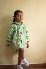 Poster - Cute little girl with pigtails holding colorful pencils in her hand