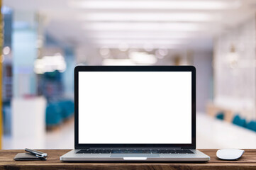 Desk Laptop with blank screen on table of coffee shop blur background