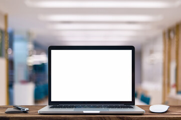 Desk Laptop with blank screen on table of coffee shop blur background